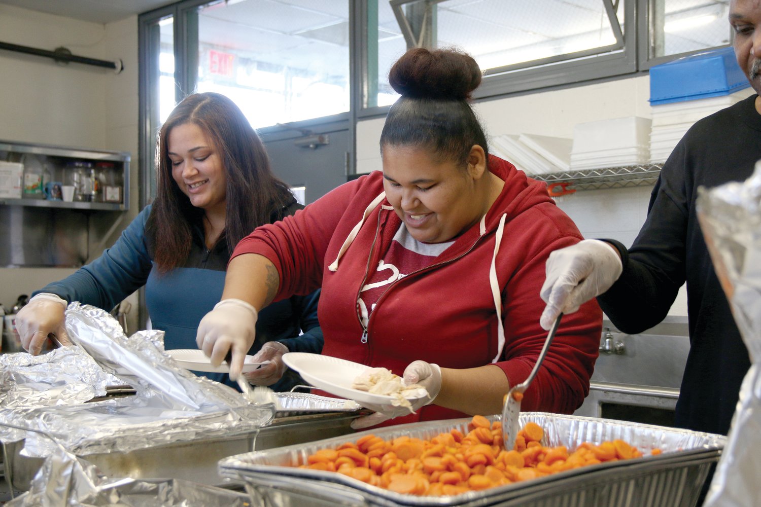 Volunteers serve Thanksgiving meals at Emmanuel House. Responding to the urgent need for additional emergency homeless shelters in December of 2010, Bishop Thomas J. Tobin opened Emmanuel House to provide a warm place to sleep for those without a home.